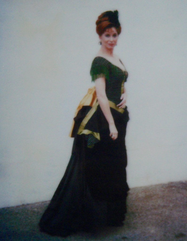 A Woman in a Black and Green Old Ball Gown Side