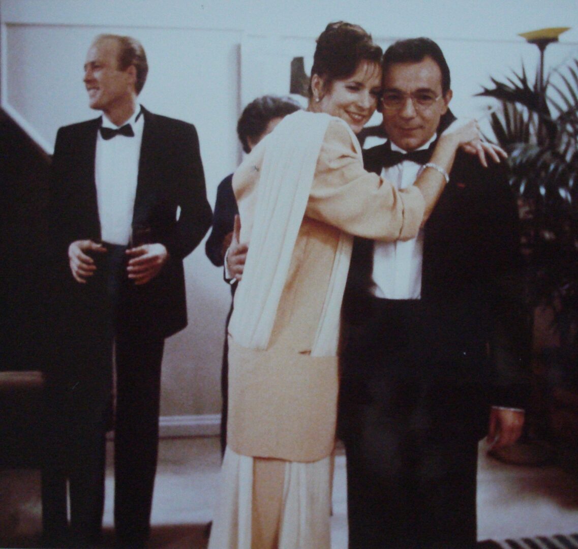 A Scene in Philip Banter With Two Actors Hugging